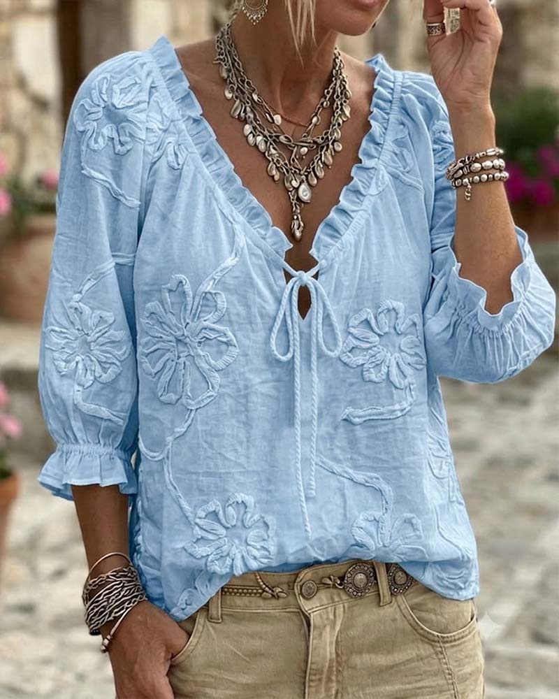 Blusa de algodón 100%, escote en V envolvente, con lazo y volantes